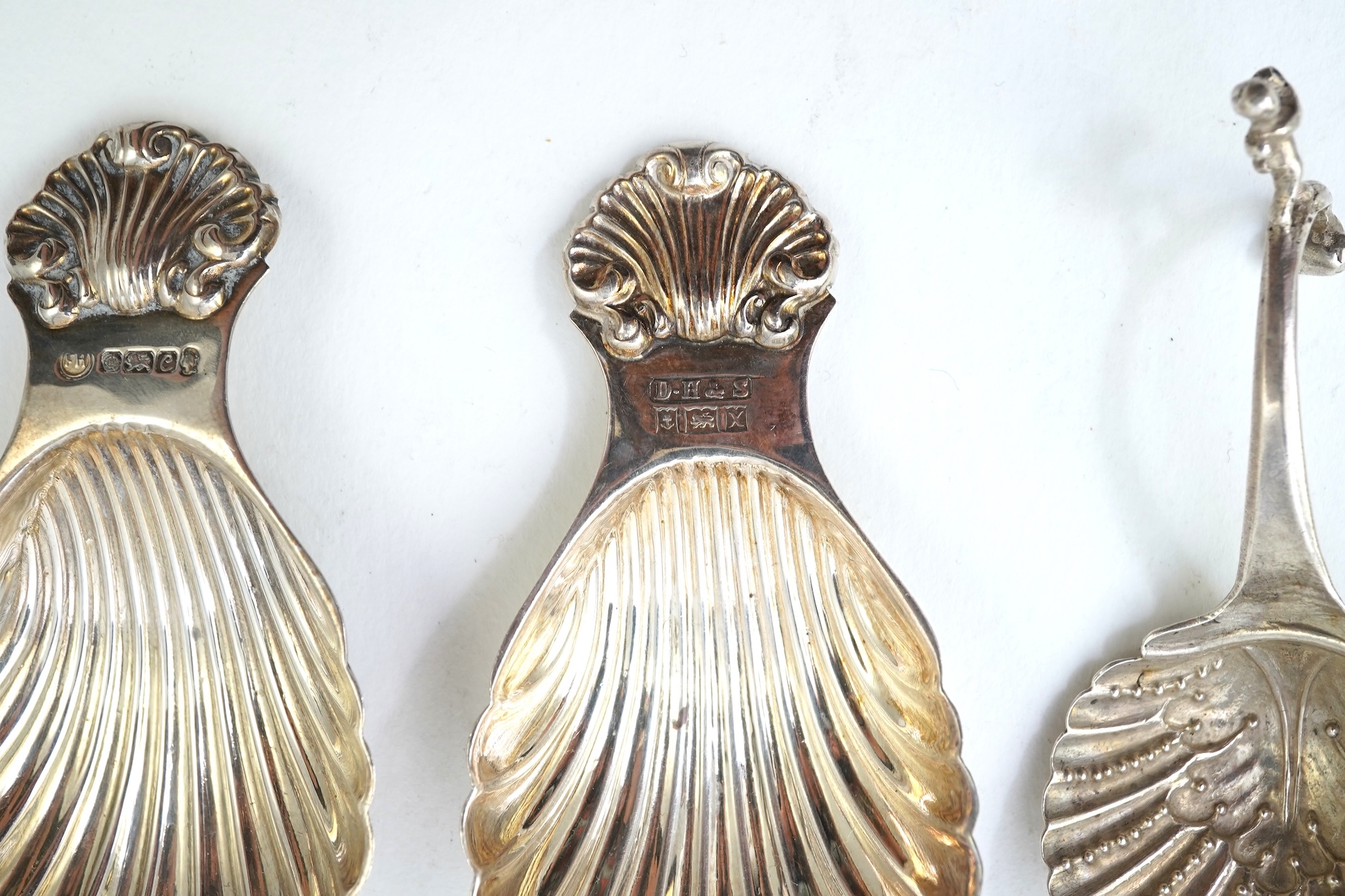 Ten assorted 19th and 20th century silver caddy spoons, with shell or fluted bowls